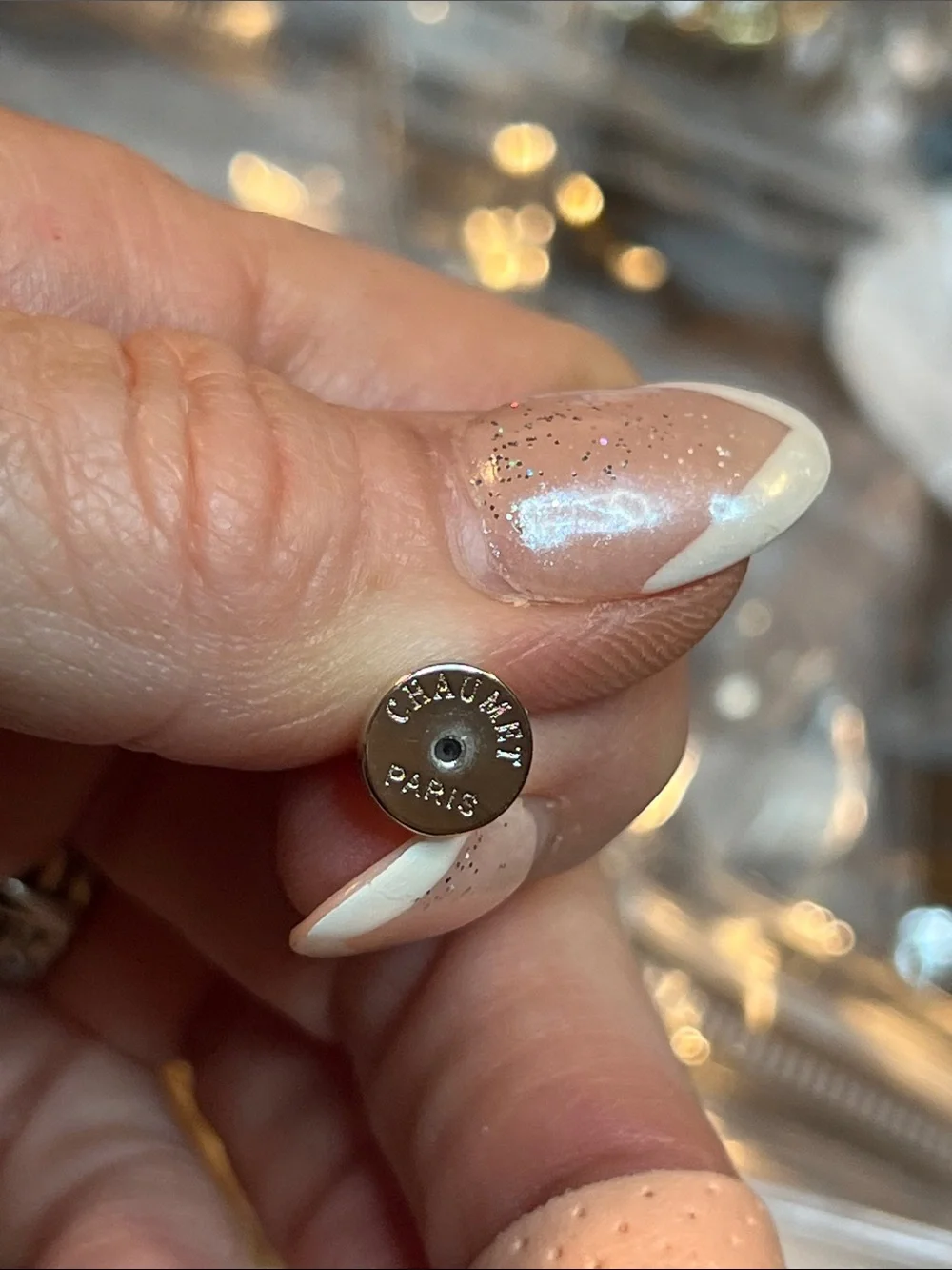 Round  Blue Zirconia In a Gold Setting With Logo